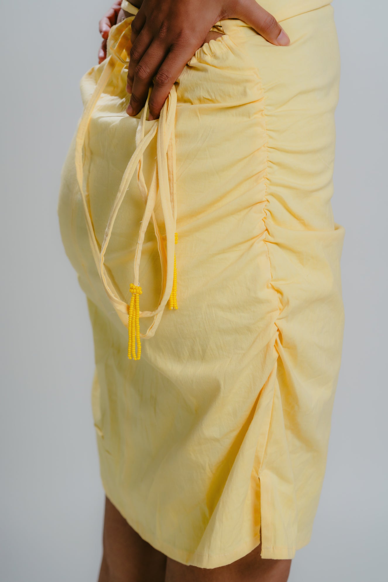 Yellow bodycon dress with strappy back design an bead details