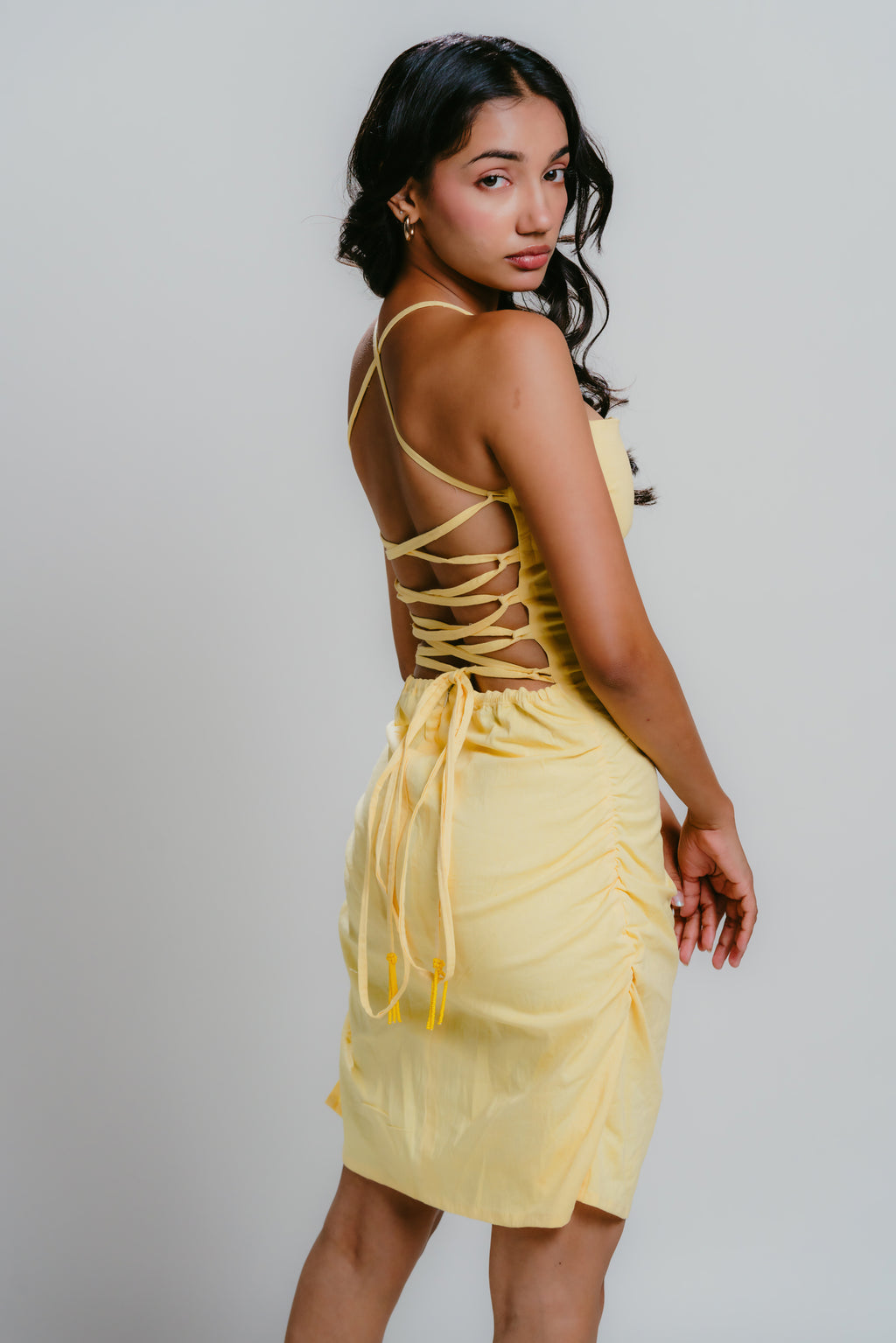 Yellow bodycon dress with strappy back design an bead details