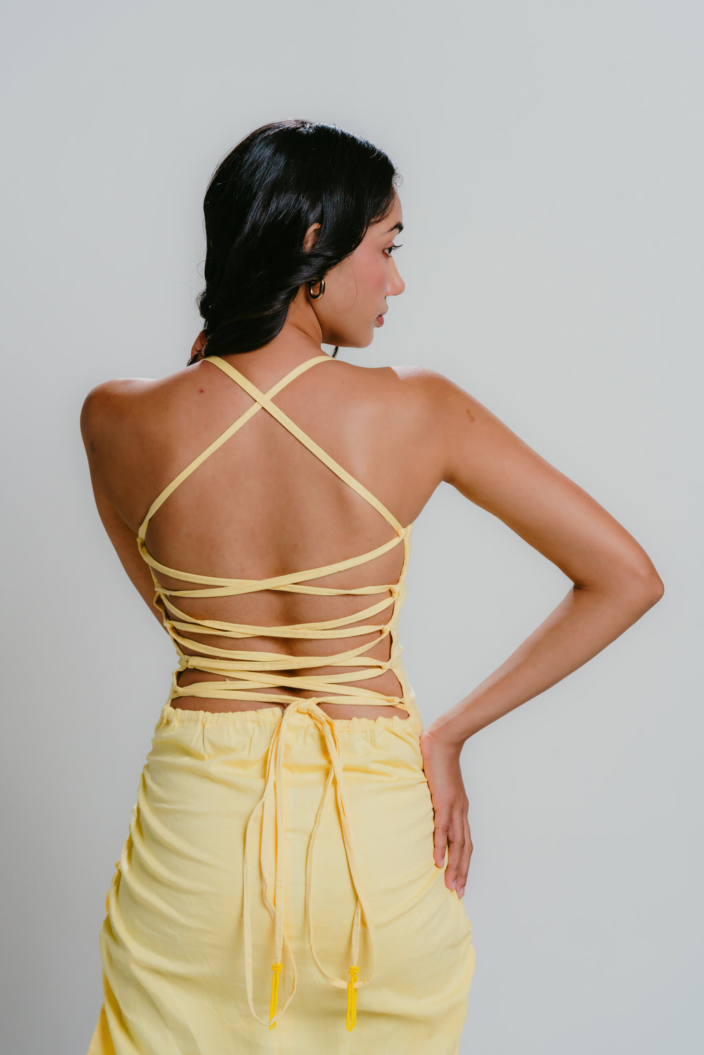 Yellow bodycon dress with strappy back design an bead details