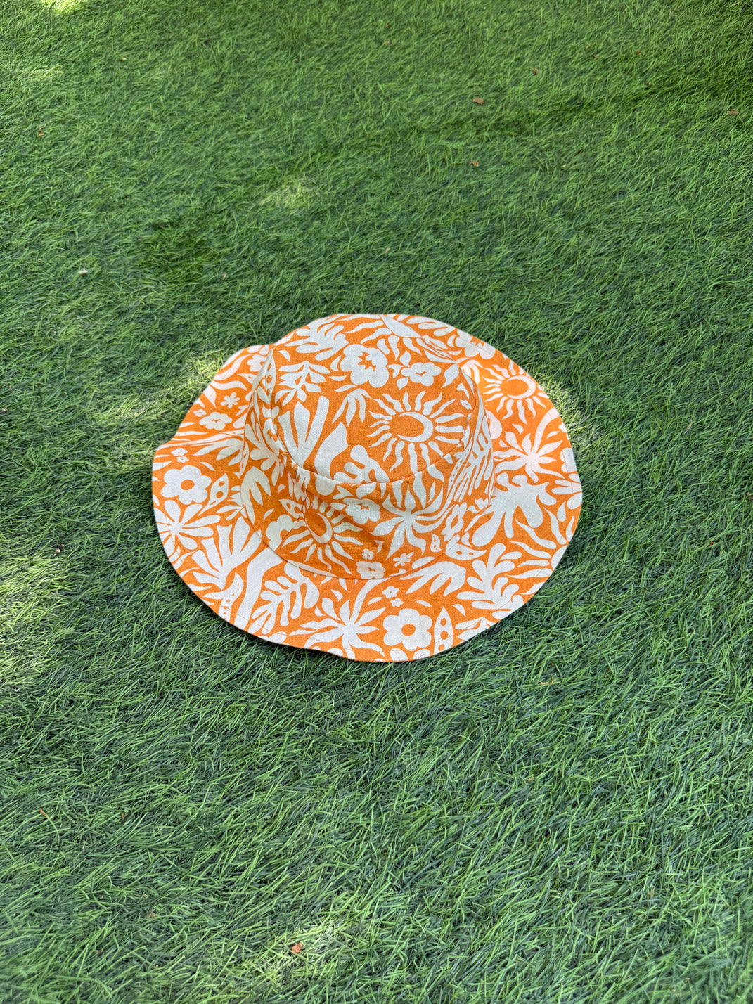 Orange and white printed bucket hat