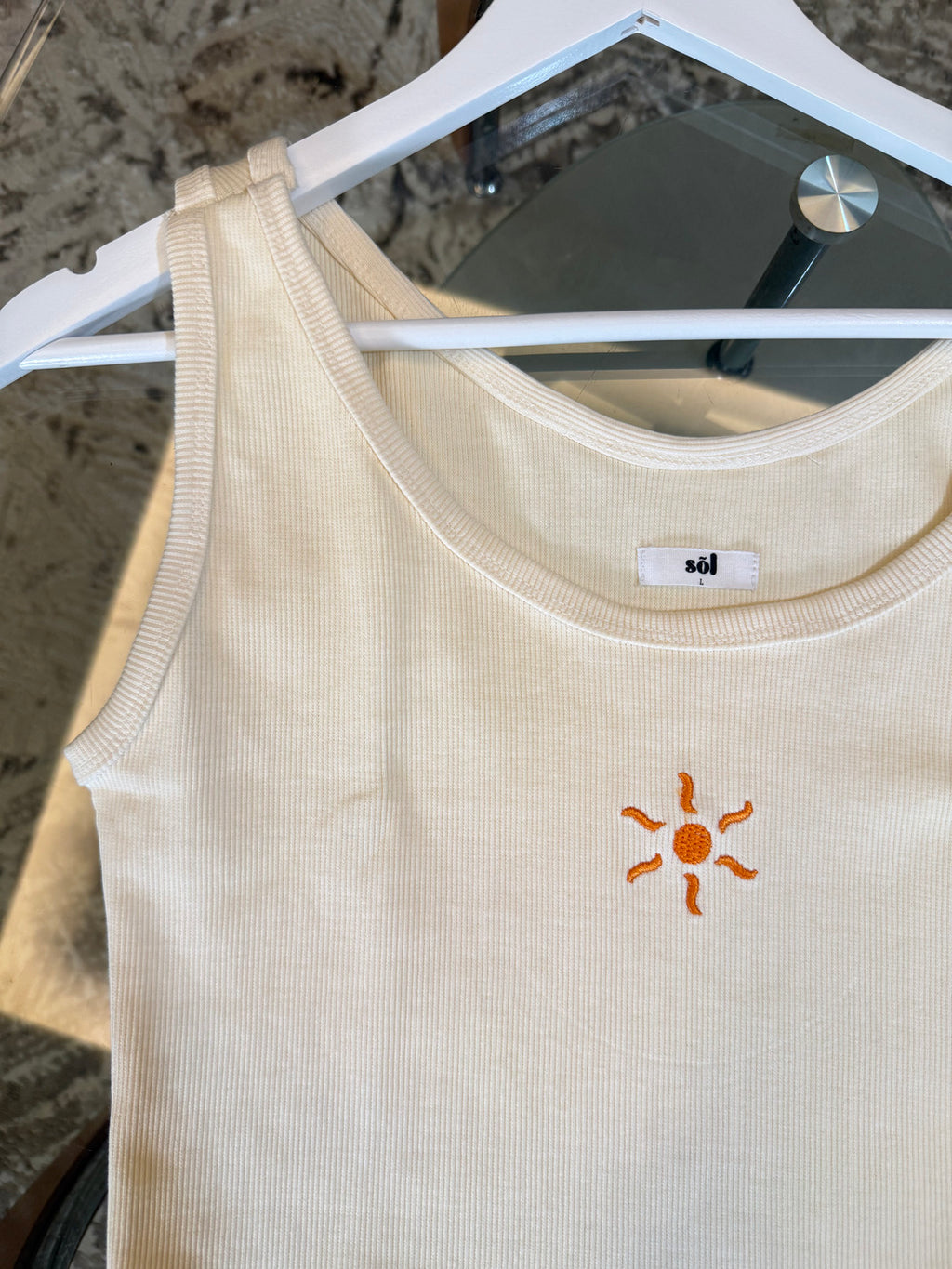 Beige tank top with a sun embroidered detail